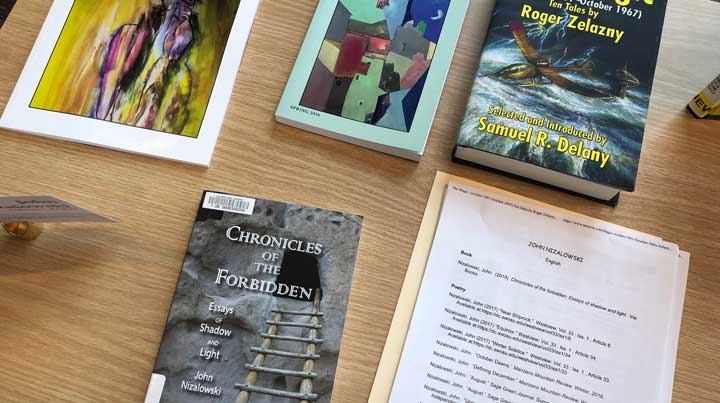 Instructor of English John Nizalowski's books including his most recent publication "Chronicles of the Forbidden".